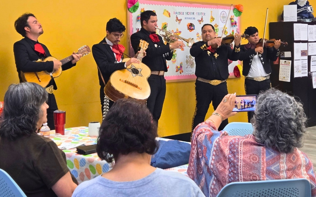 Mariachi group performing for seniors.