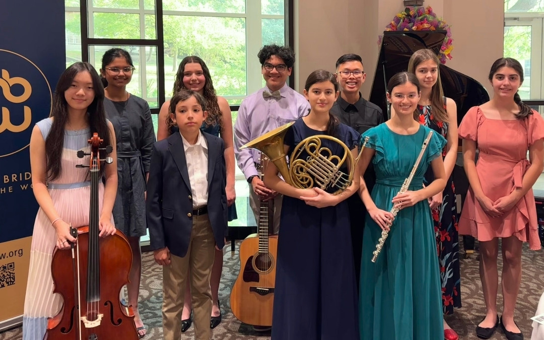 Youth ambassadors posing with their instruments after a concert.